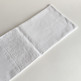 Detail of the embroidered fleur-de-lys motif on the jacquard cotton