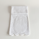 Antique white cotton hand towel with floral and fleur-de-lys jacquard, laid flat