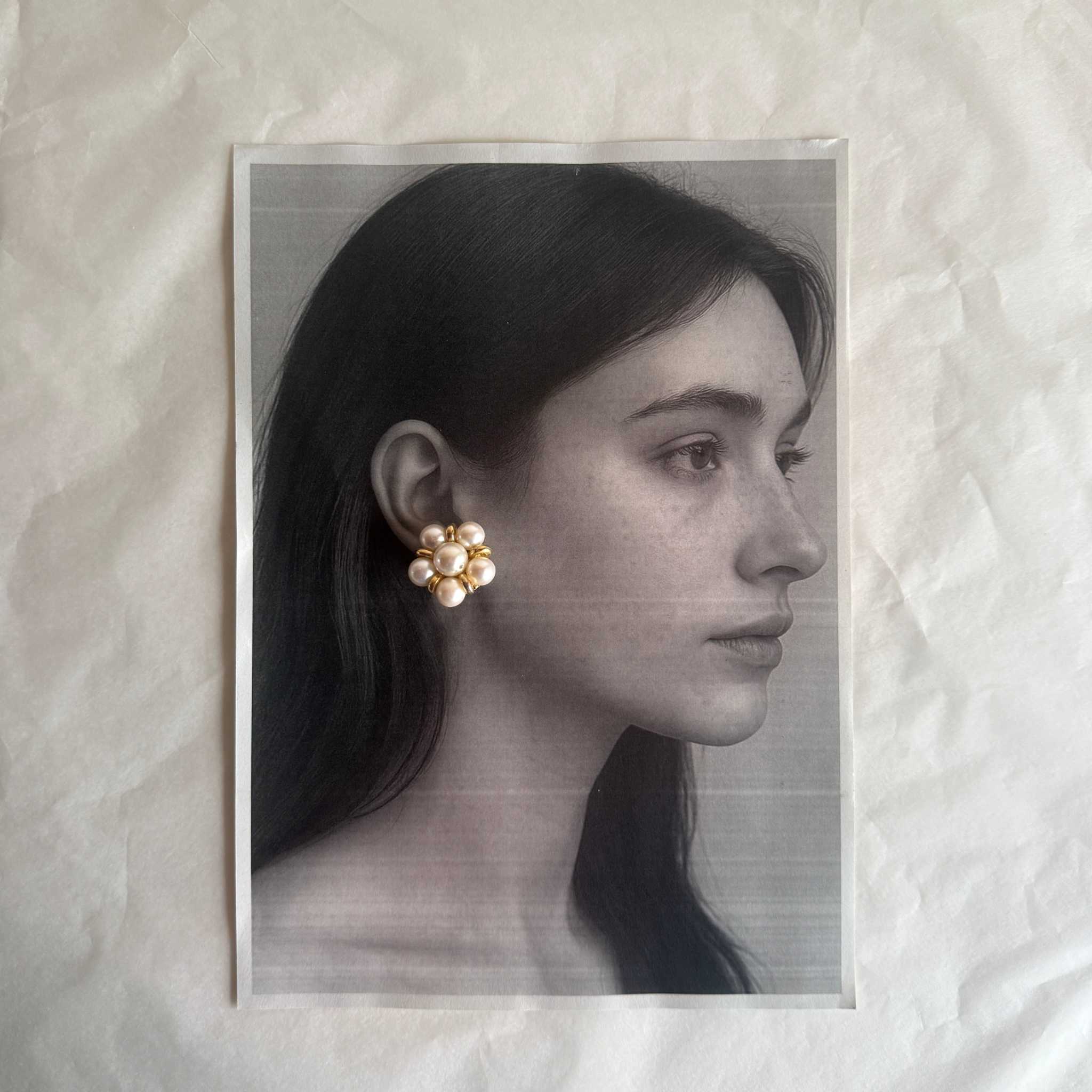 Elegant pearl clip earrings with faux pearls and gold-tone metal, showcasing vintage charm and pre-loved character