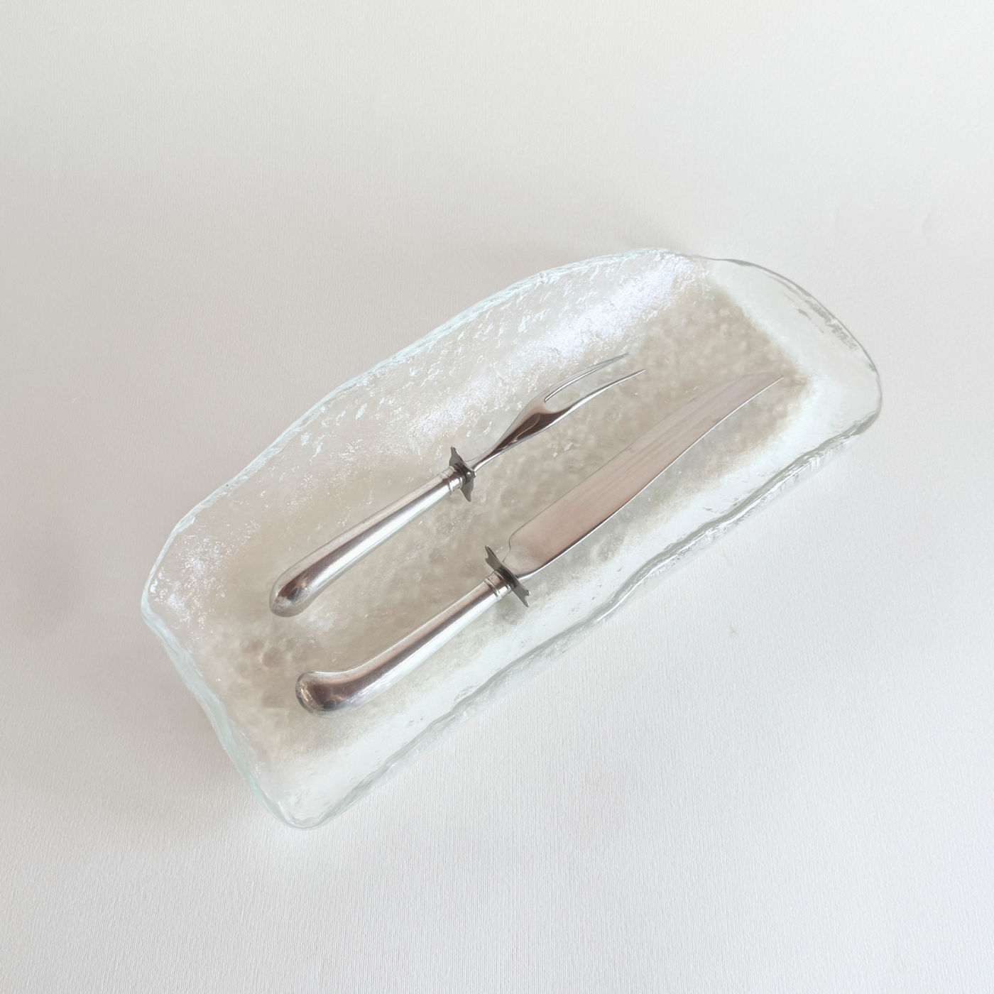 Vintage silver-plate carving set, knife and fork, 1980s European, on a laid table