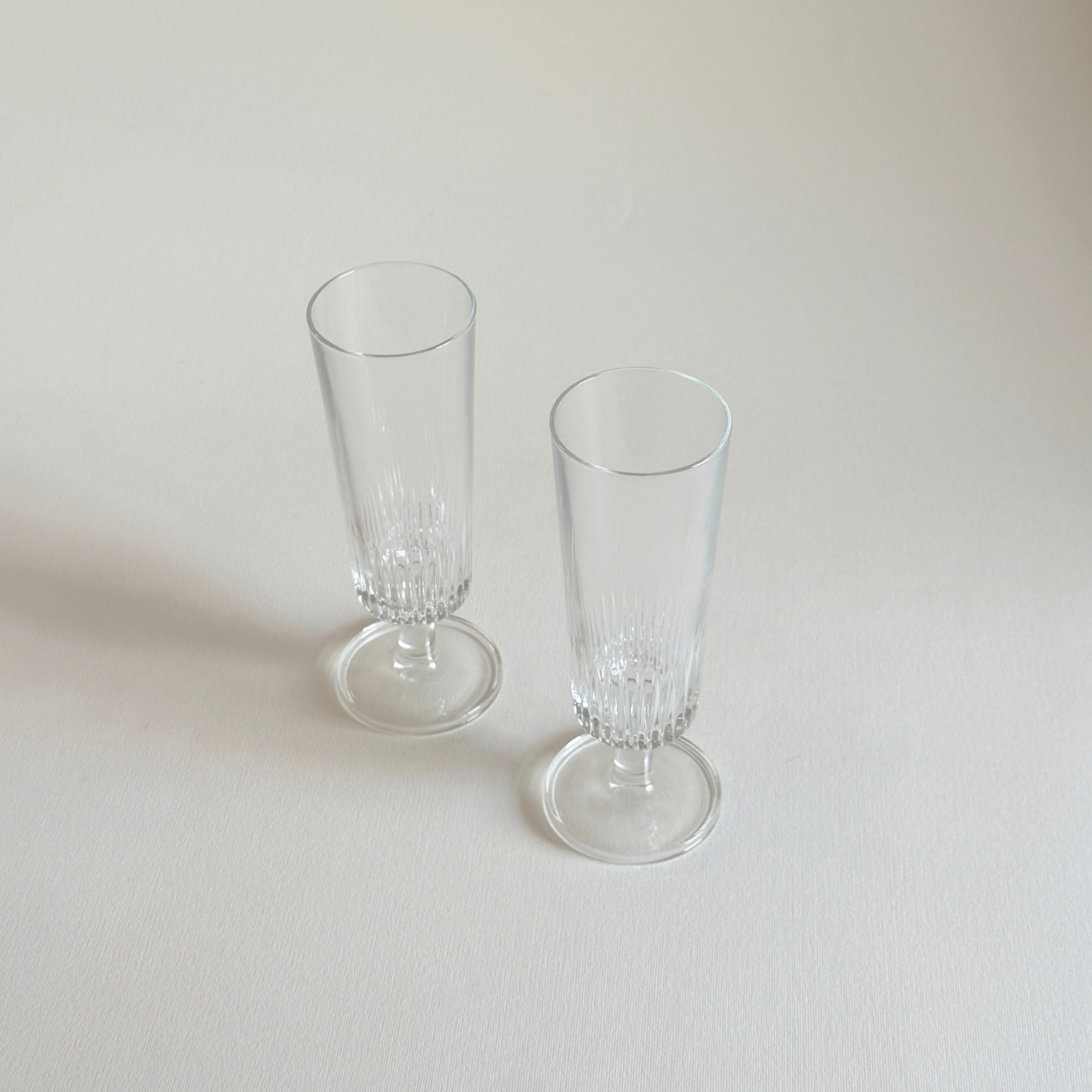 Glass Champagne Flutes, set of two clear glass glasses with ribbed vertical detailing and slender stems