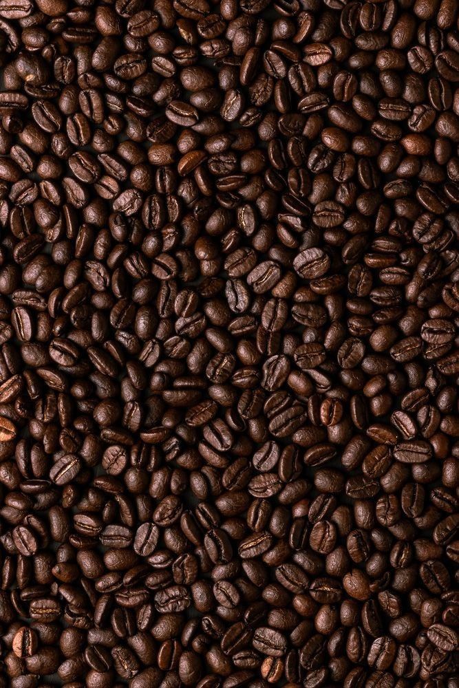 Close-up of coffee beans with a dark brown color.