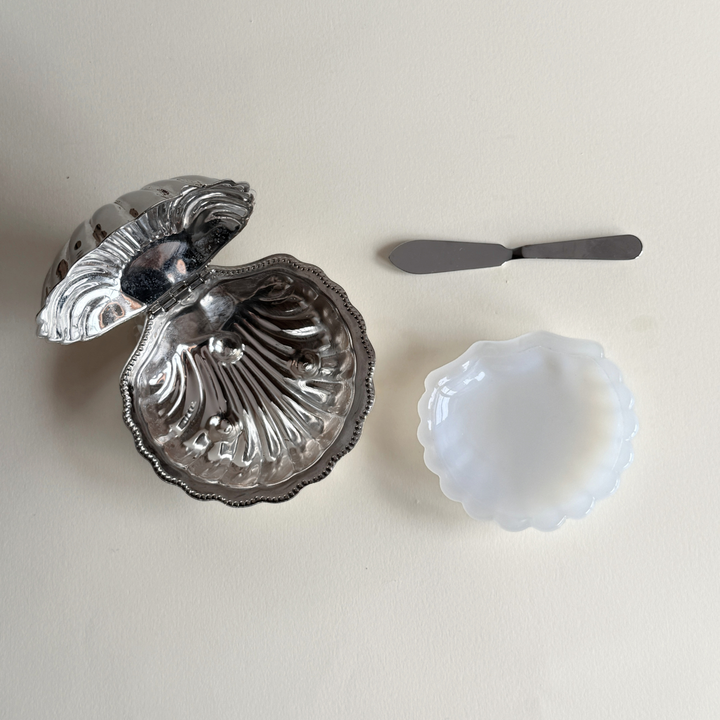 Pre-loved silver butter dish with discolouration and corrosion detail