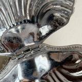 Pre-loved silver butter dish with discolouration and corrosion detail close up