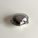 Compact silver shell serving dish for caviar and butter presentation