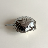 Compact silver shell serving dish for caviar and butter presentation