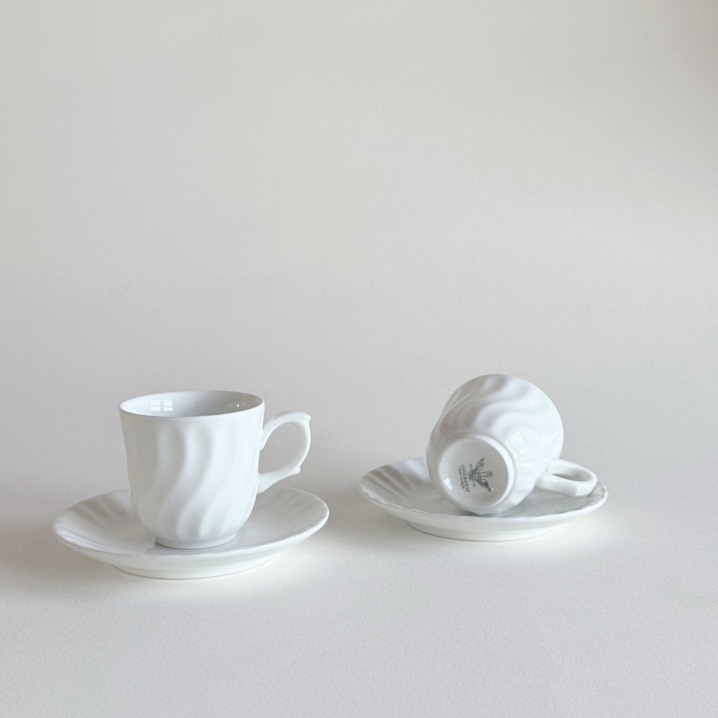 Small white espresso cups styled for coffee serving