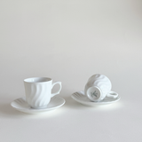 Small white espresso cups styled for coffee serving