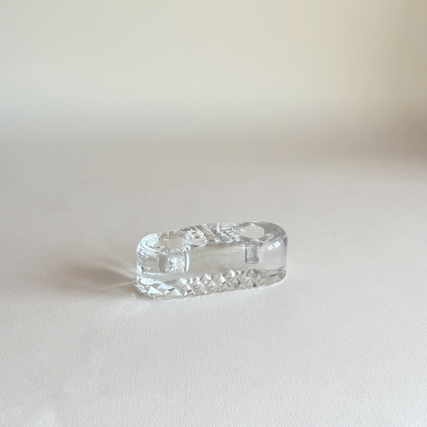 Vintage Iittala candle holder in clear pressed glass, side view showing the low horizontal form