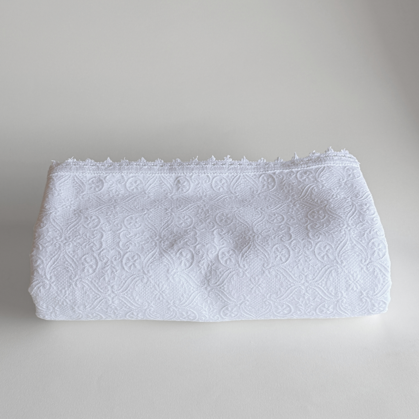 1970s Italian cotton jacquard bedspread with trim edge on bed