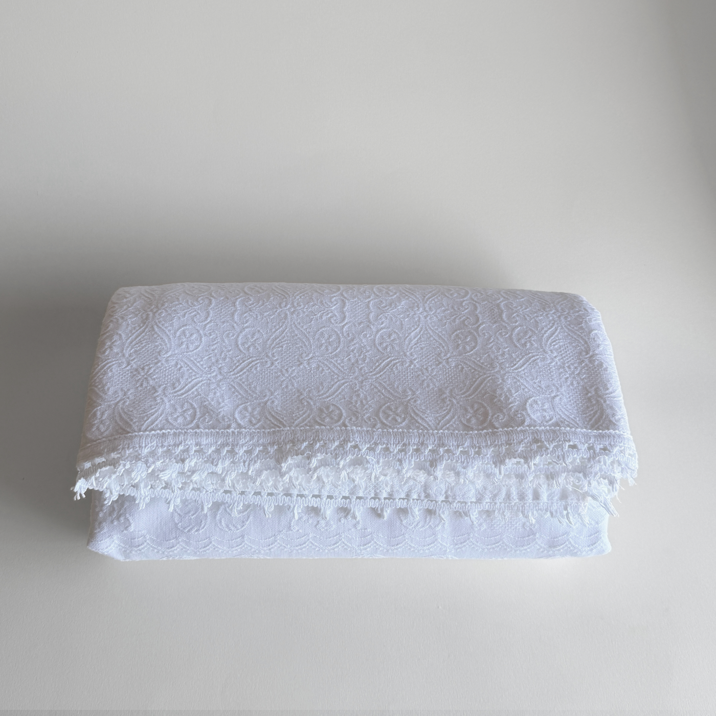 1970s Italian cotton jacquard bedspread with trim edge on bed