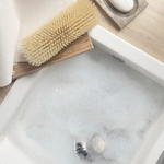 Cleaning brush and soap on a marble surface