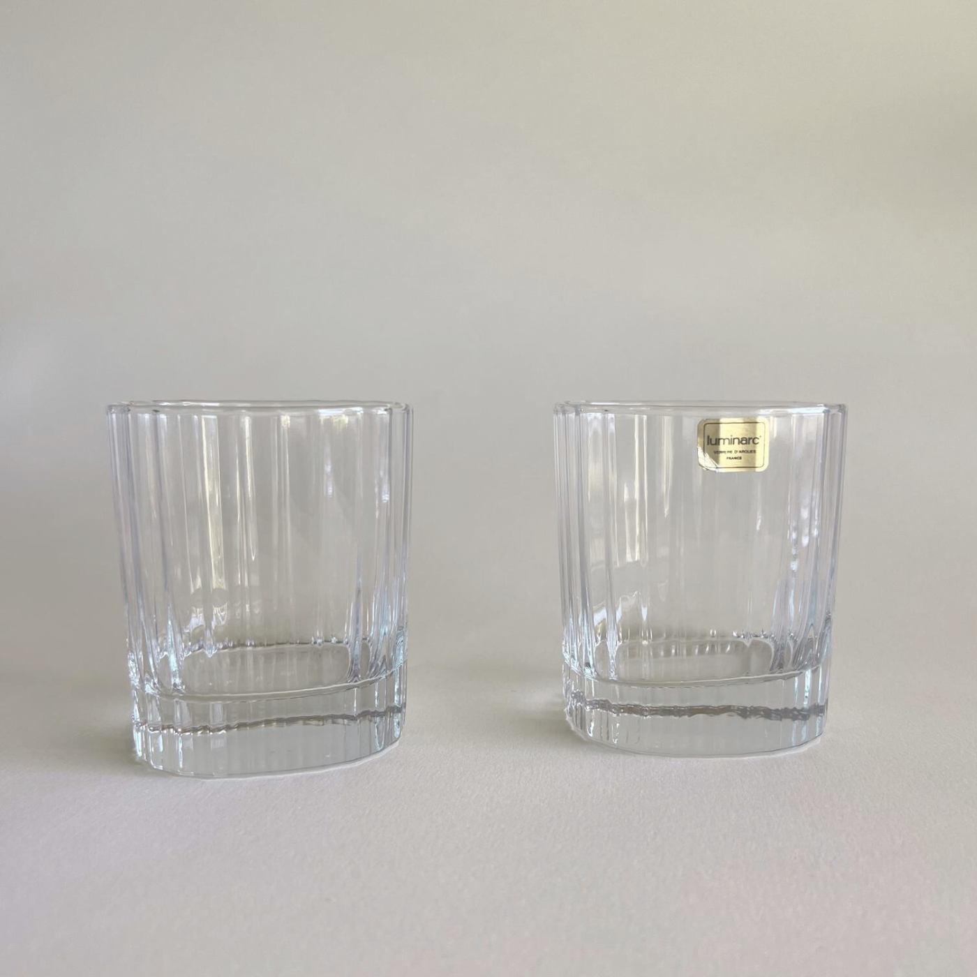 Whisky tumbler with striped glass design on table