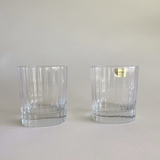 Whisky tumbler with striped glass design on table