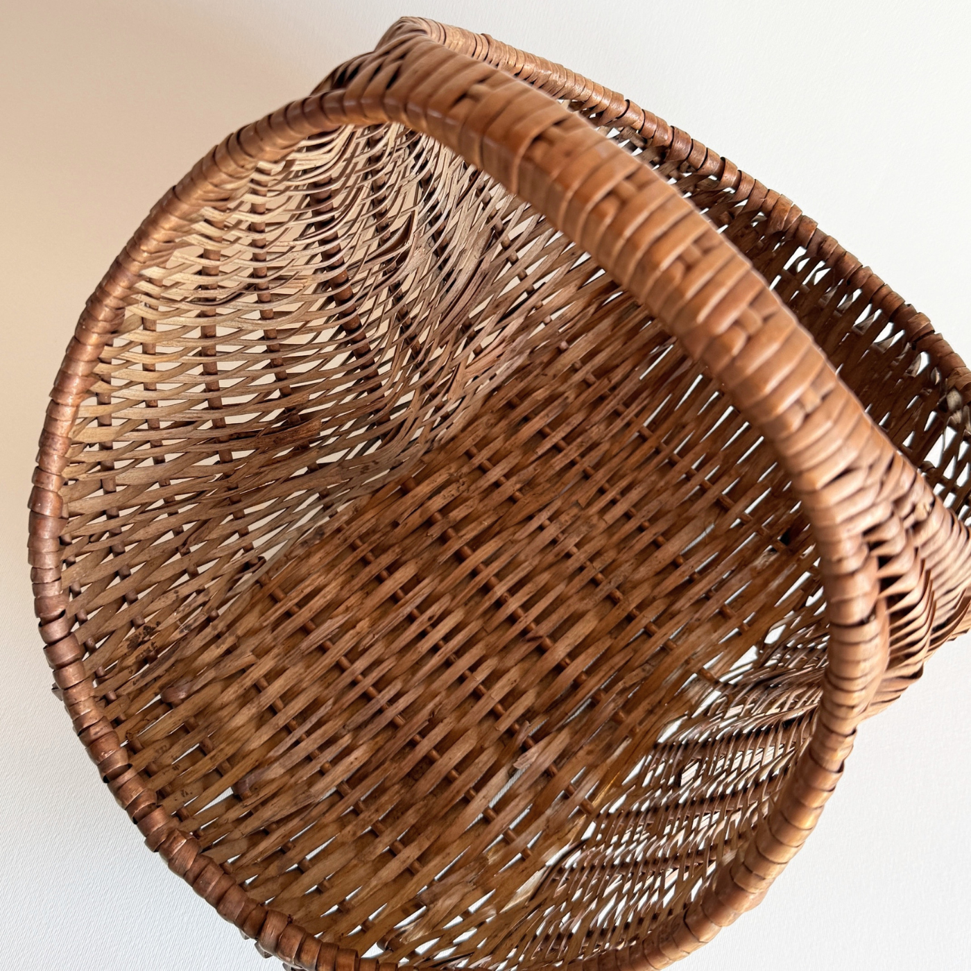 1970s Italian rattan crescent moon basket with dark close weave and deep body