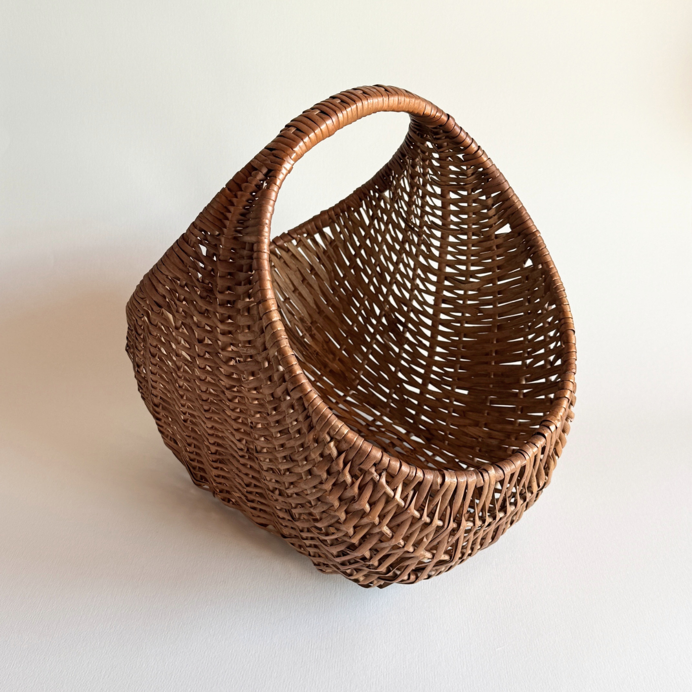 1970s Italian rattan crescent moon basket with dark close weave