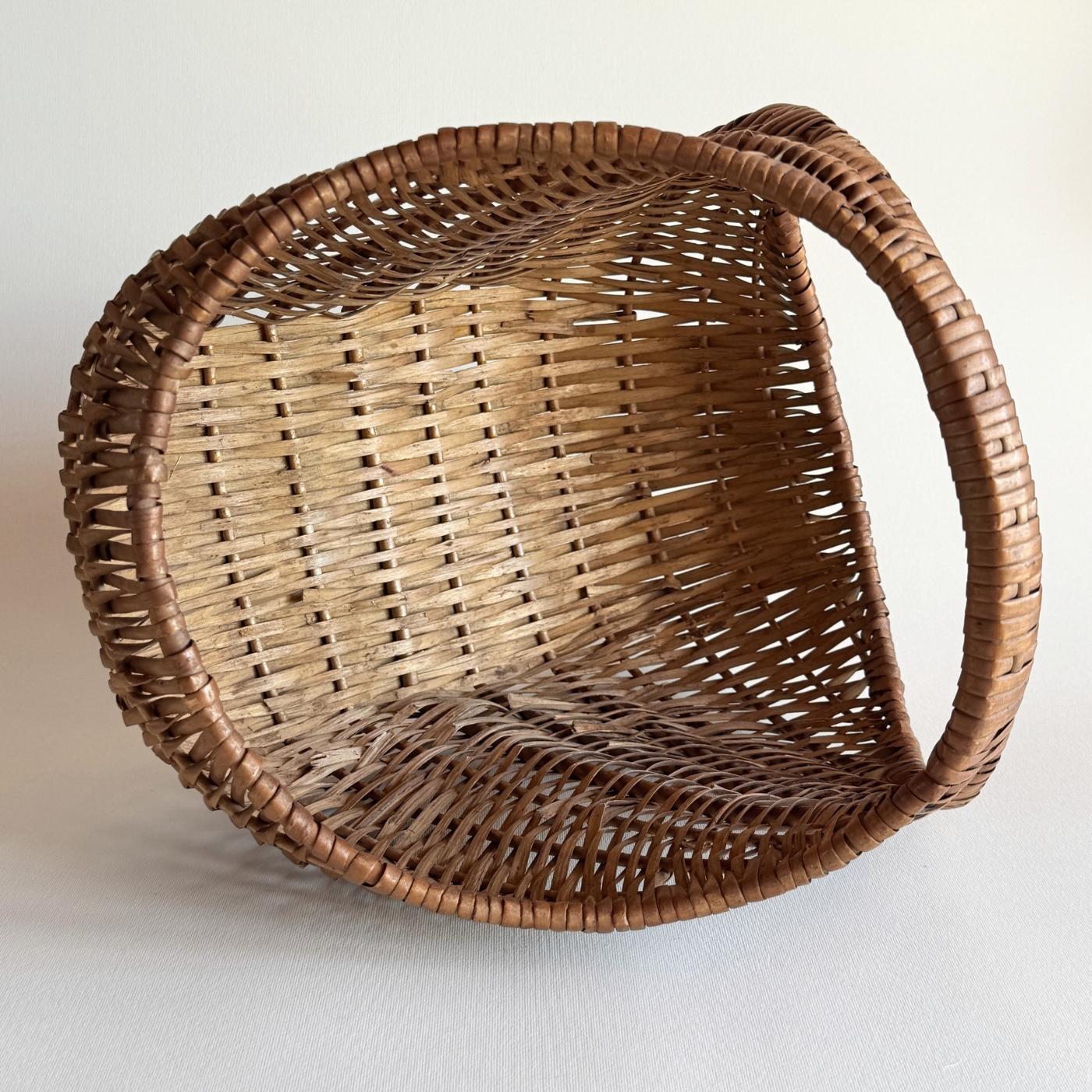 1970s Italian rattan crescent moon basket with dark hand-weave
