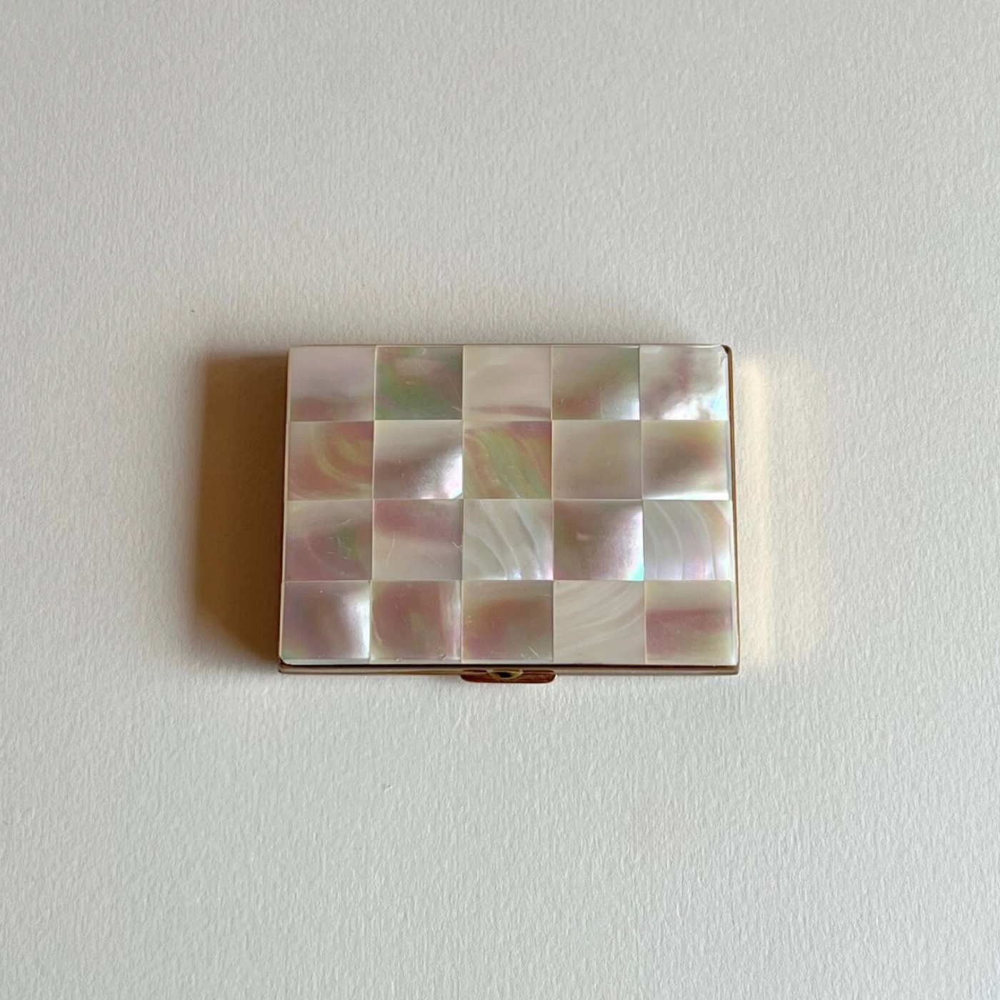 Collectible compact case with mother of pearl finish