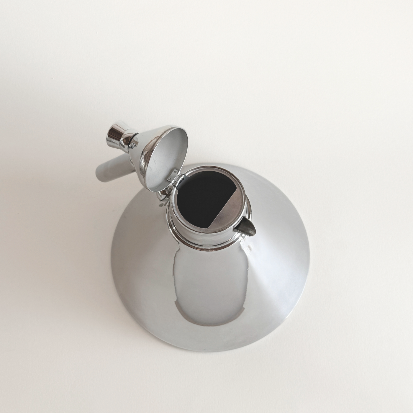 Stainless steel kettle with clean geometric form and ergonomic handle