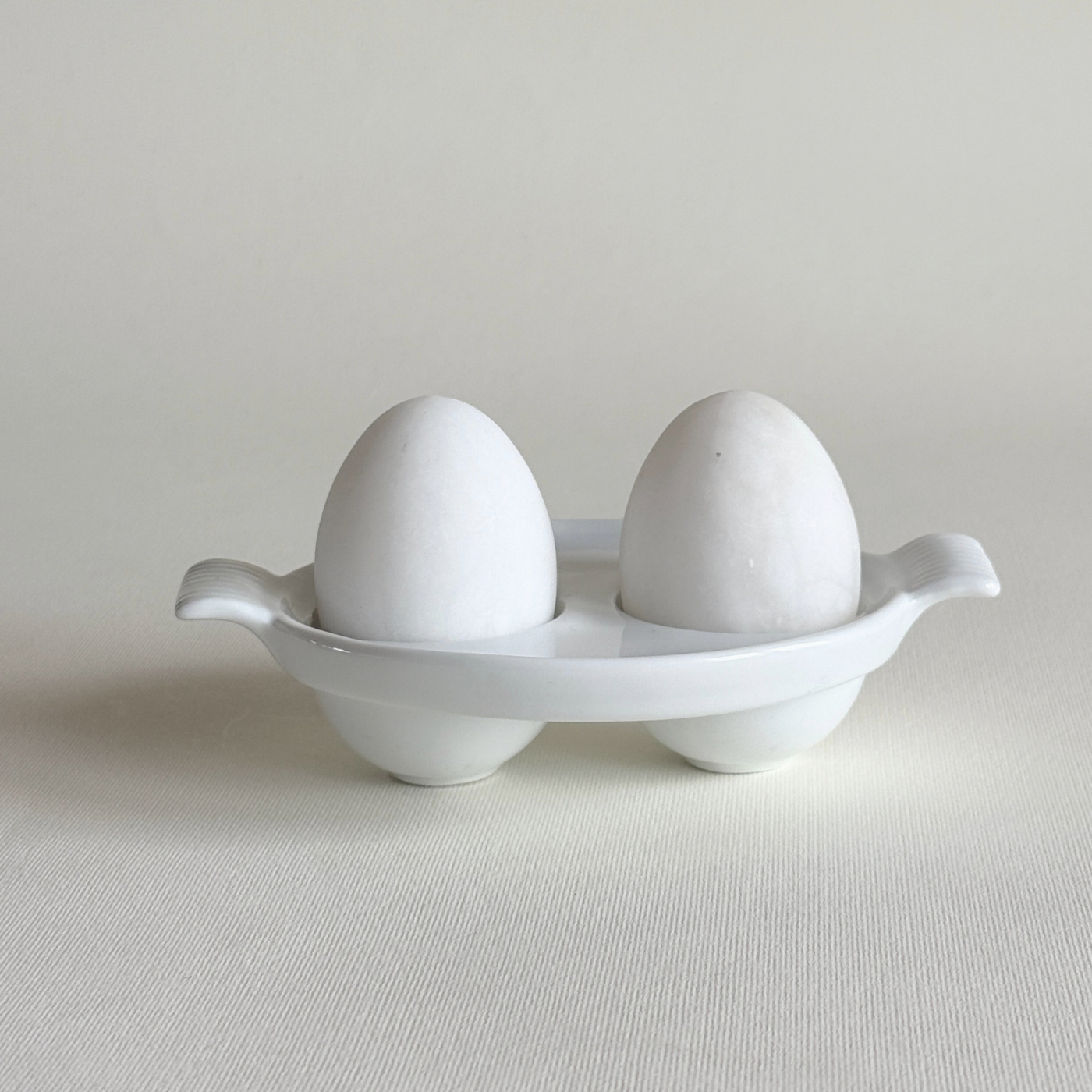 white ceramic double egg cup