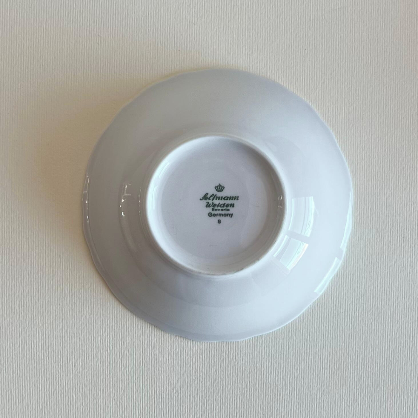 Refined table setting with Fleur de Lis porcelain bowls with scalloped edges