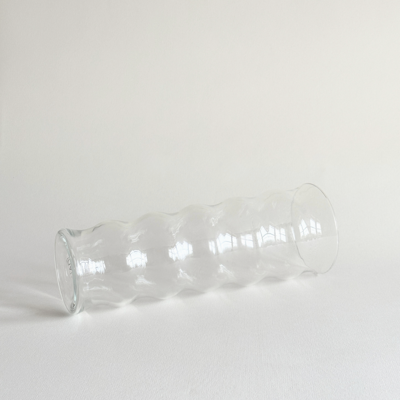 Detail of the rippled texture on the clear glass vase body