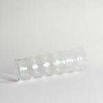 Detail of the rippled texture on the clear glass vase body