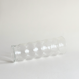 Detail of the rippled texture on the clear glass vase body