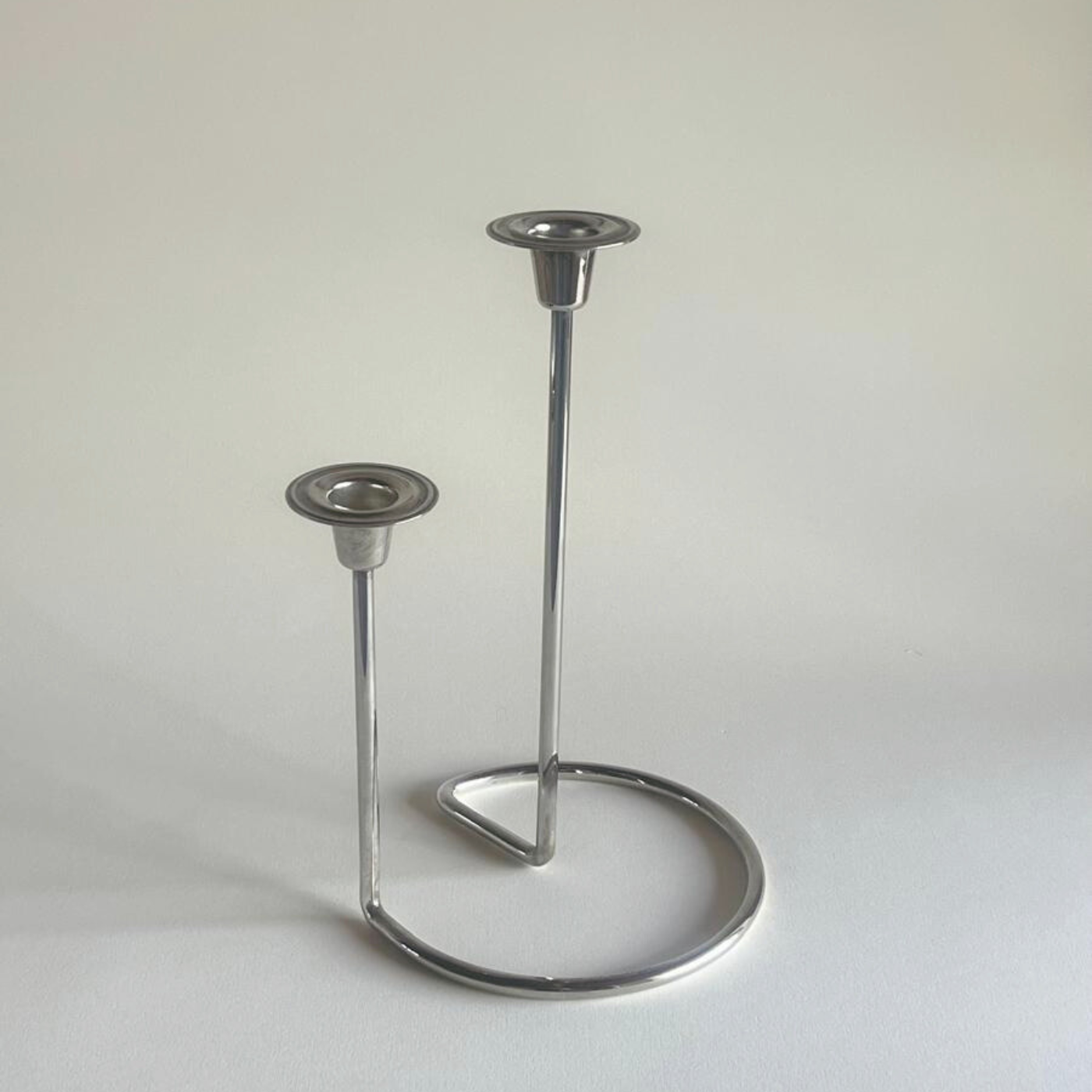 Mid century silver candle decor styled on table