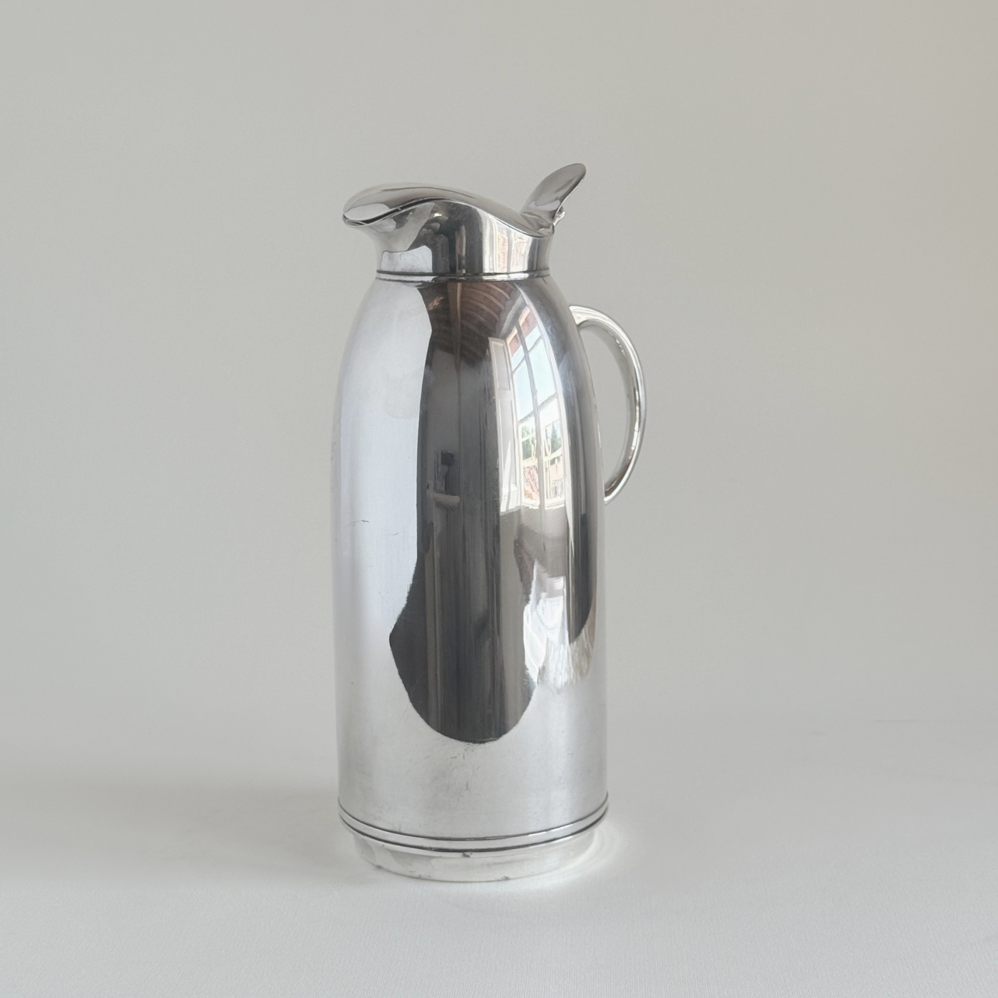 Silver plated thermos jug — close-up of hinged flip-top lid and integrated spout detail
