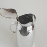 Silver plated thermos jug — top view showing hinged lid open and interior with pink glass lining, 1 L capacity