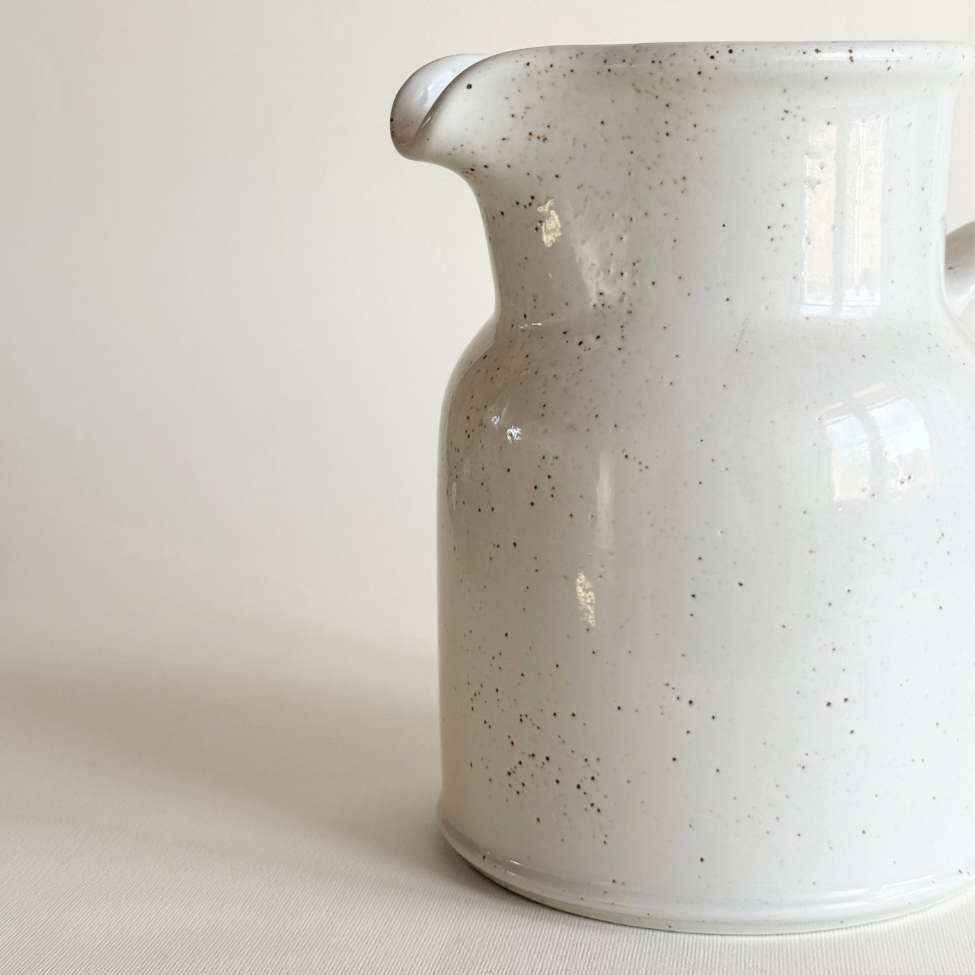 White stoneware pentik jug with brown splatter pattern kitchen ware