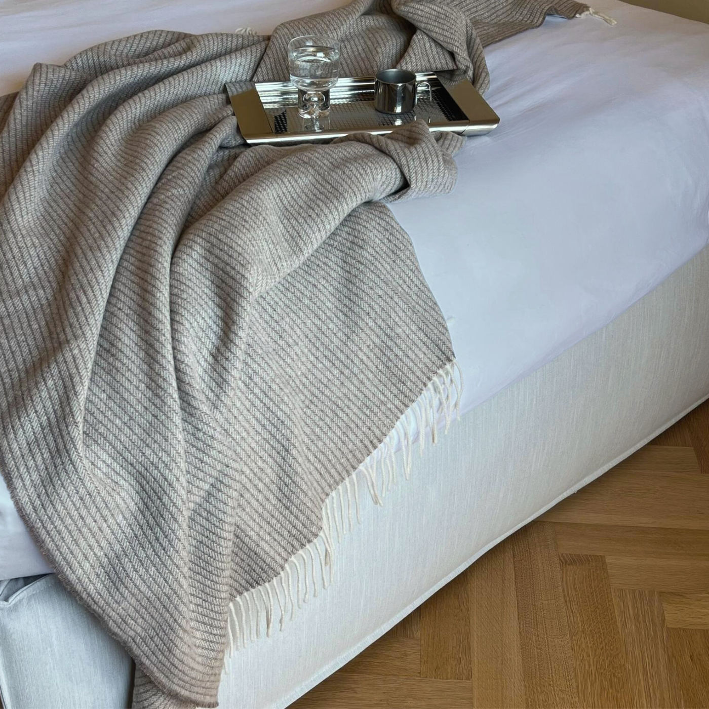 Throws-cashmere-wool-brawn-taupe-blanket-beige-on bed with metal espresso cup