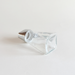 Glass sugar dispenser tipped to show the metered pour spout