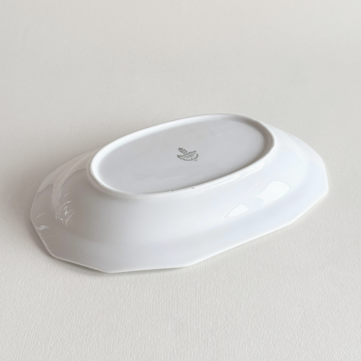White porcelain rectangular tray in profile showing the low raised edge
