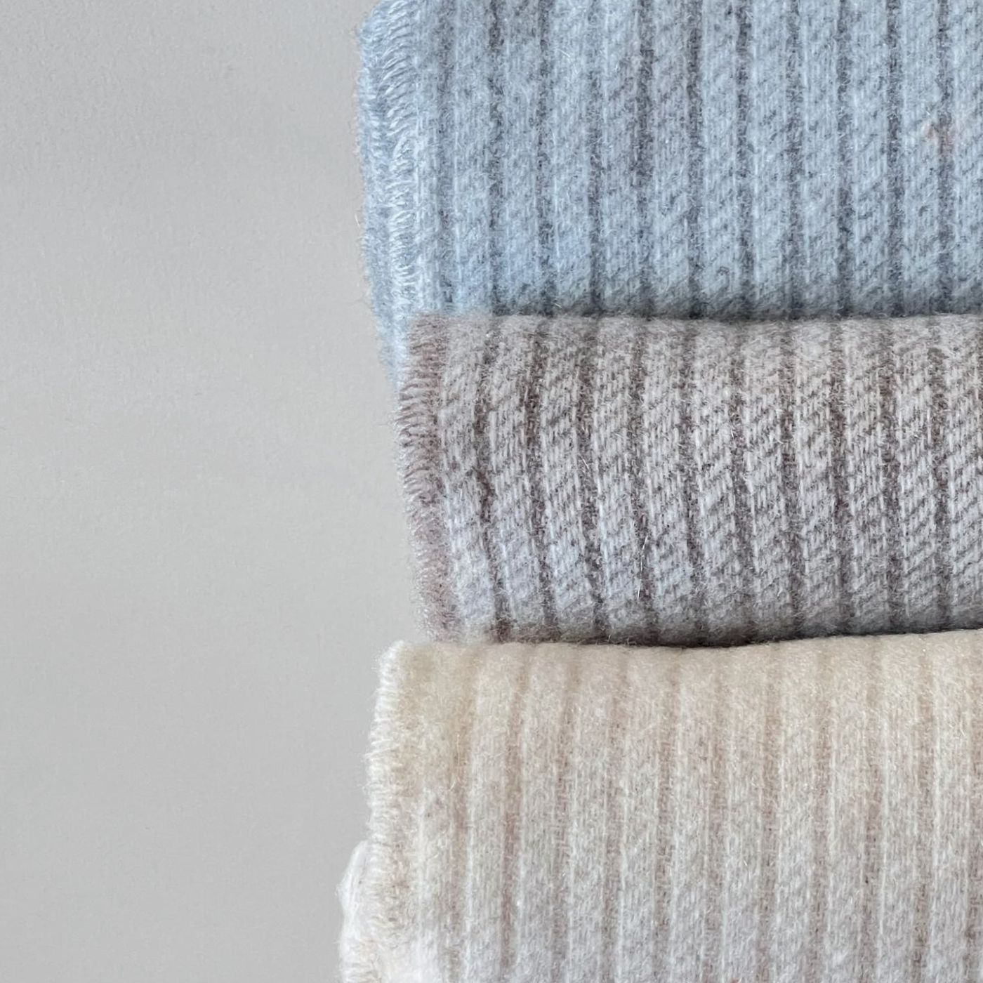 Throws cashmere wool blanket beige on bed with metal espresso cup