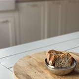 bowl on a wooden cutting board with a kitchen background