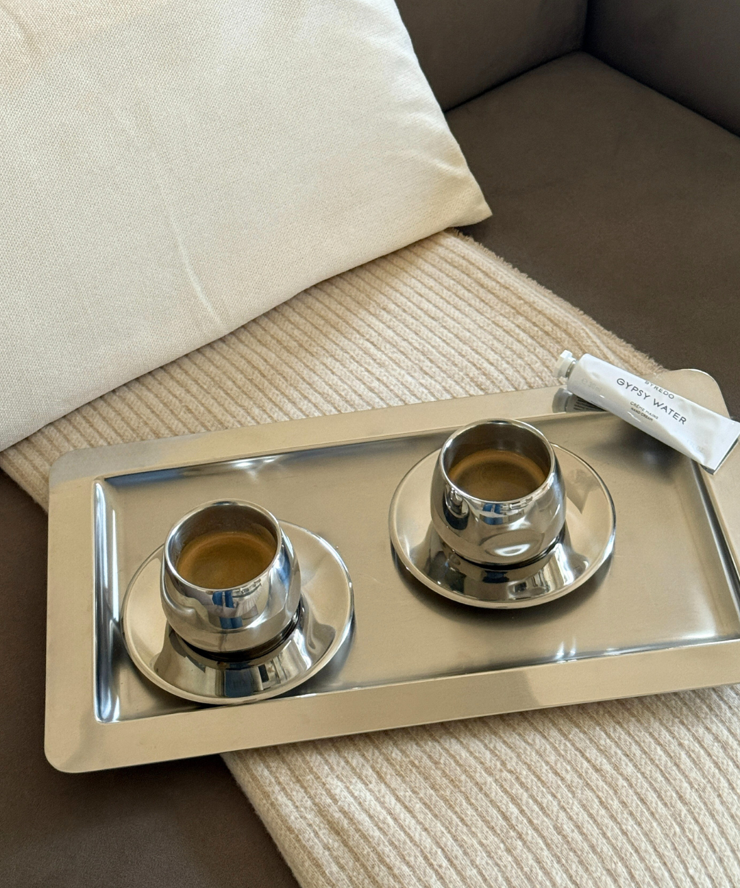 amc coffee cup art design on cashmere blancket, silver tray and gypsy water by byredo