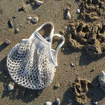 Mini ecru cotton net bag by Filt 1860 shown folded flat, plastic-free French knitted mesh