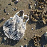 Mini ecru cotton net bag by Filt 1860 shown folded flat, plastic-free French knitted mesh