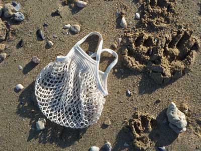 Mini ecru cotton net bag by Filt 1860 shown folded flat, plastic-free French knitted mesh