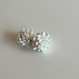 Sculptural white floral clip-on earrings detail