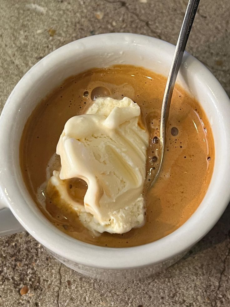 affogato Cup of coffee with a scoop of ice cream and a spoon on a concrete surface
