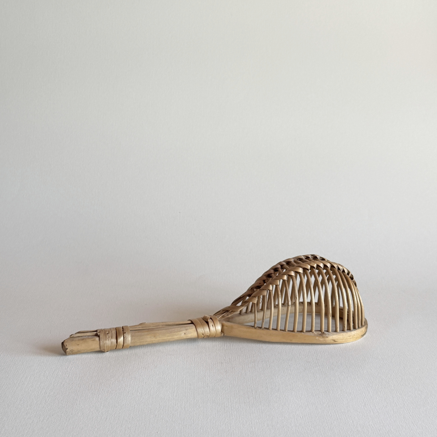 Elongated 1960s Italian rattan kitchen colander with open-weave design for draining herbs and vegetables