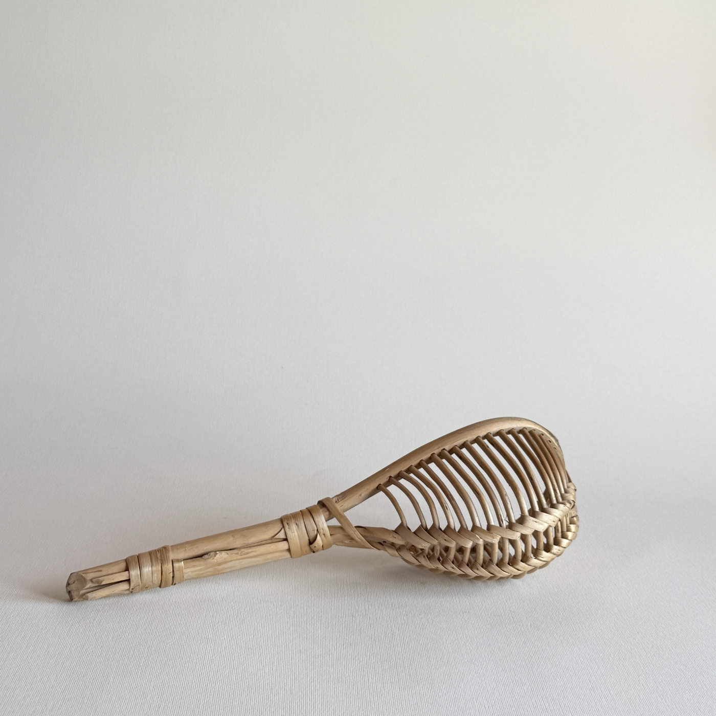 1960s Italian rattan kitchen colander with elongated open-weave design for draining herbs and vegetables