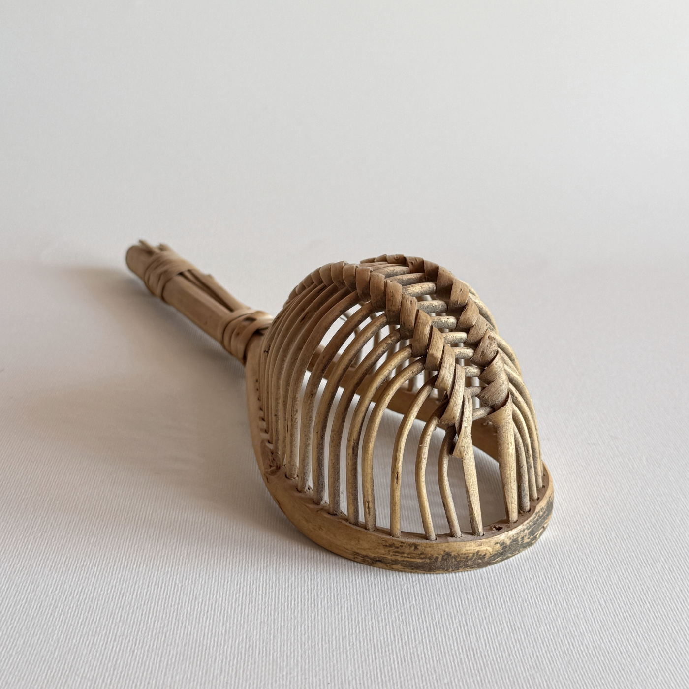 1960s Italian rattan kitchen colander with elongated open-weave design for draining herbs and vegetables