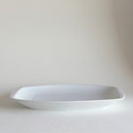 Ceramic Serving Dish in white glazed ceramic with rectangular shape, rounded corners, and a subtle raised leaf-relief border detail.