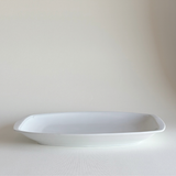 Ceramic Serving Dish in white glazed ceramic with rectangular shape, rounded corners, and a subtle raised leaf-relief border detail.