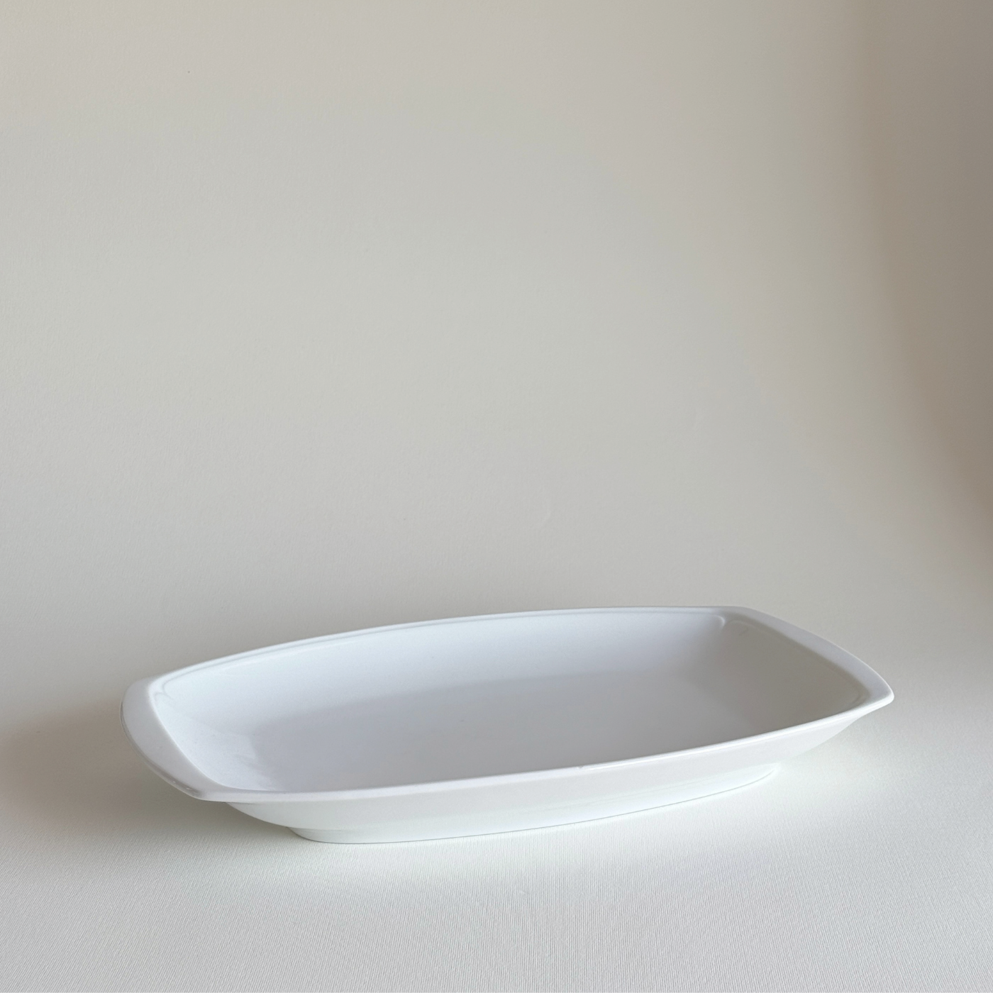 Ceramic Serving Dish in white glazed ceramic with a smooth finish, rectangular shape, and gently rounded corners.