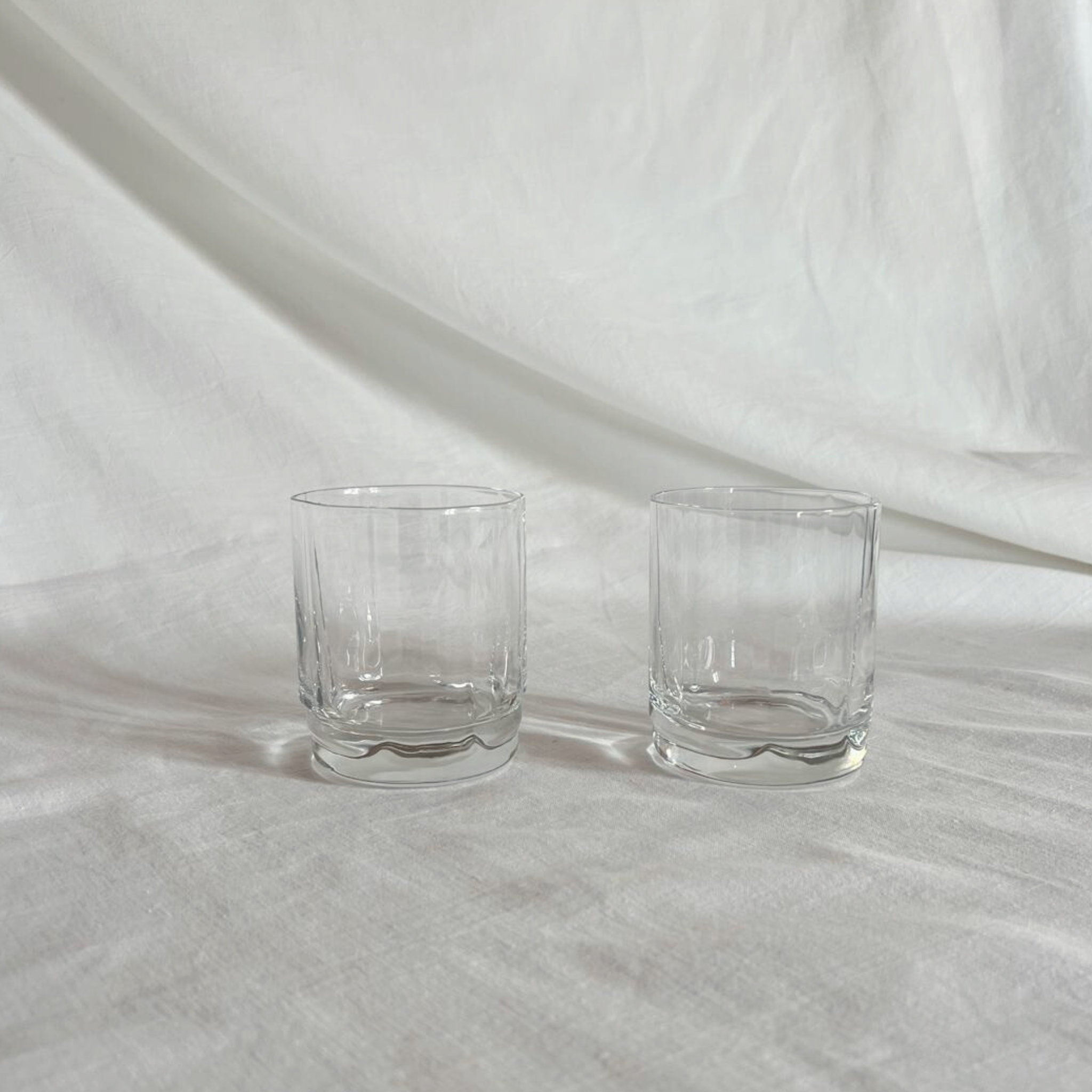 Set of 2 elegant scalloped glass tumblers with intricate curved design for stylish sipping